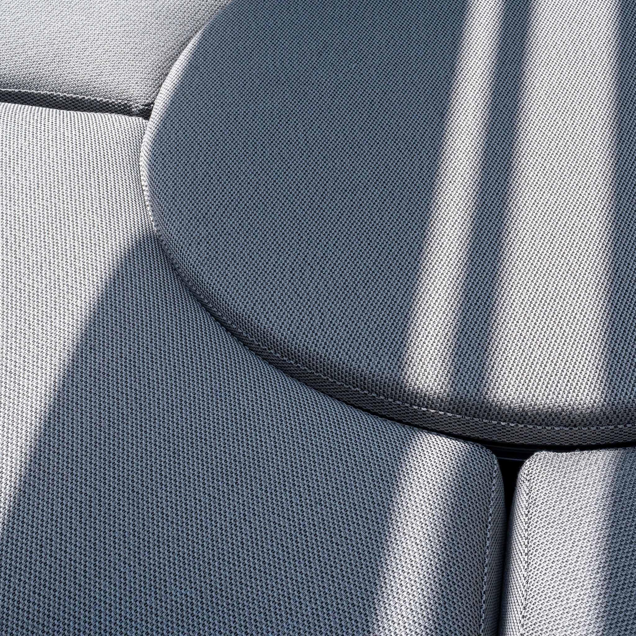 Close-up view of modern grey circular fabric cushions with shadows cast across them, featuring the Luna Outdoor Fabric Lifestyle Suite with 4 Sofas in Grey by Harbour Lifestyle.