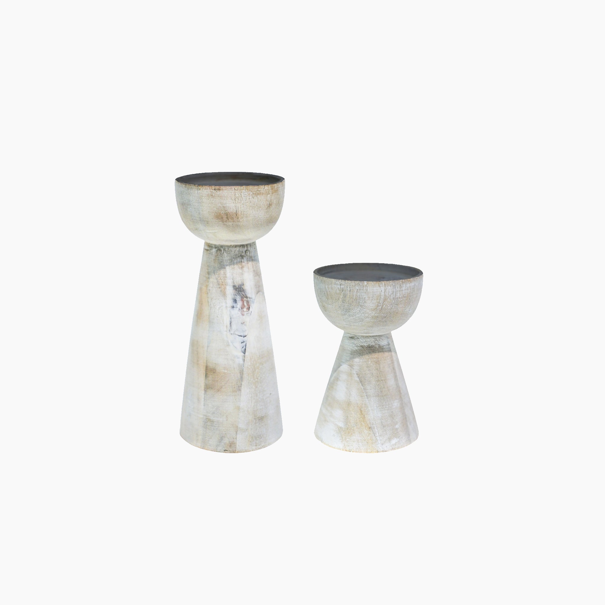 The Ivyline Padstow Whitewash set includes two wooden candle holders crafted from sustainable wood, standing elegantly against a white background. With a light, weathered finish, one is taller than the other, echoing the charm of artisanal design.