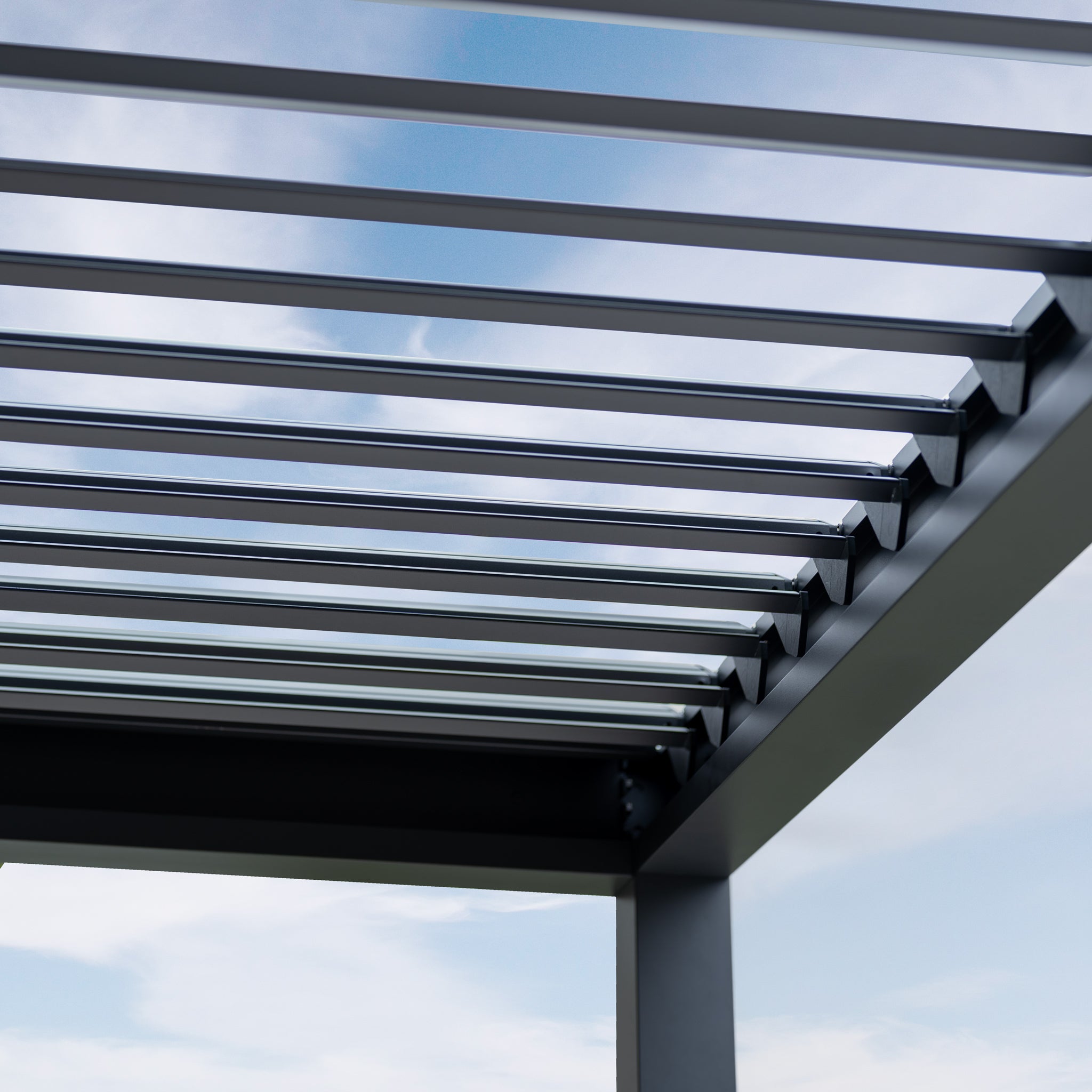 The PergoSTET Deluxe 3m x 7m Rectangular Pergola, featuring motorised LED louvres in grey, stands against a blue sky, combining style and functionality.