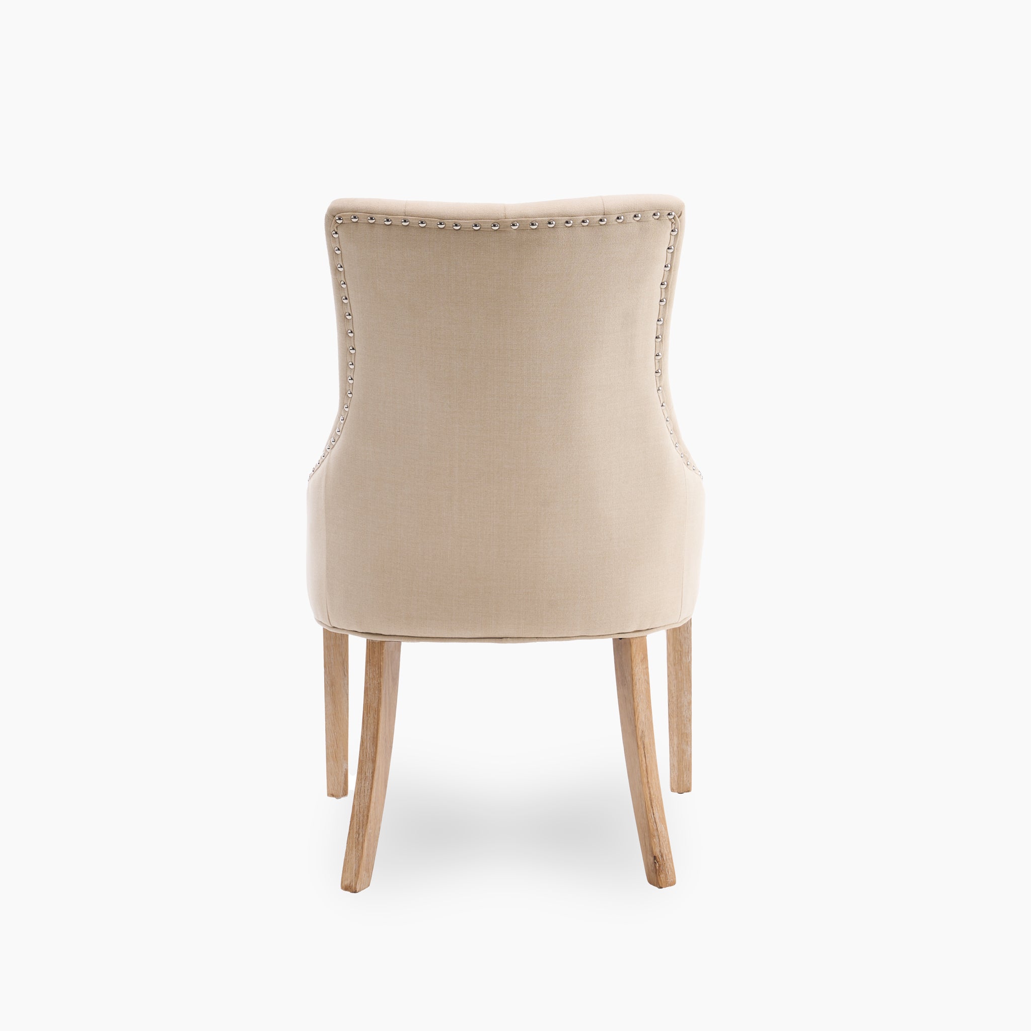 Back view of the sophisticated Regent Chair from the "Regent Chair Set of 2 in Beige," showcasing its beige upholstery with nailhead trim and robust wooden legs, positioned against a plain white background.