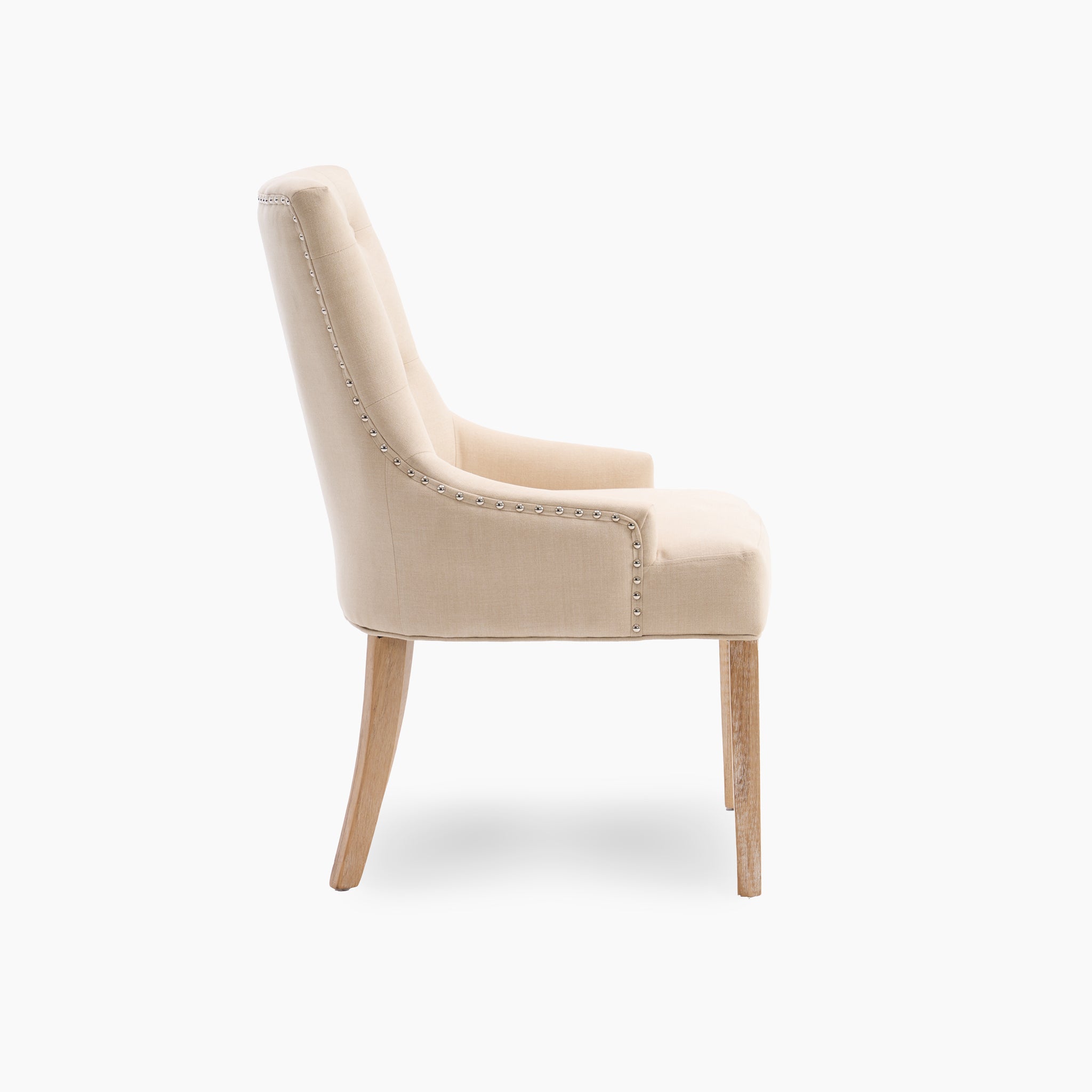 Side view of the Regent Chair Set of 2 in Beige, showcasing its tufted back with elegant wooden legs, set against a pristine white background.