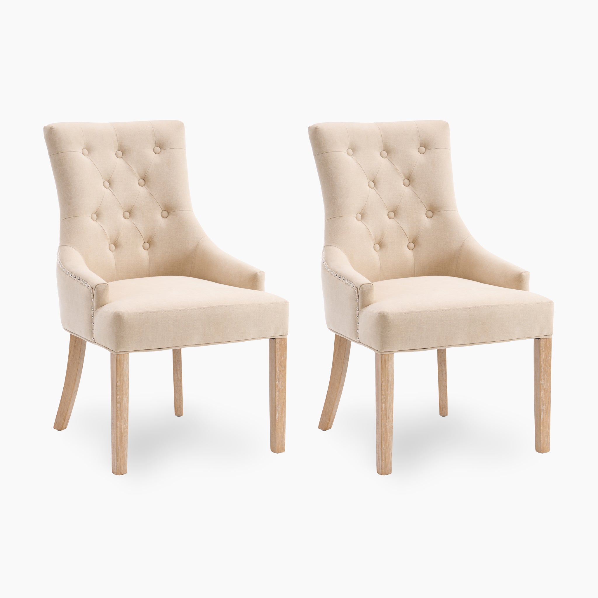 Introducing the Regent Chair Set of 2 in Beige: these elegantly designed dining chairs feature premium beige upholstery with exquisite button tufting. Supported by sturdy wooden legs, they beautifully blend classic charm with modern sophistication against a white background.