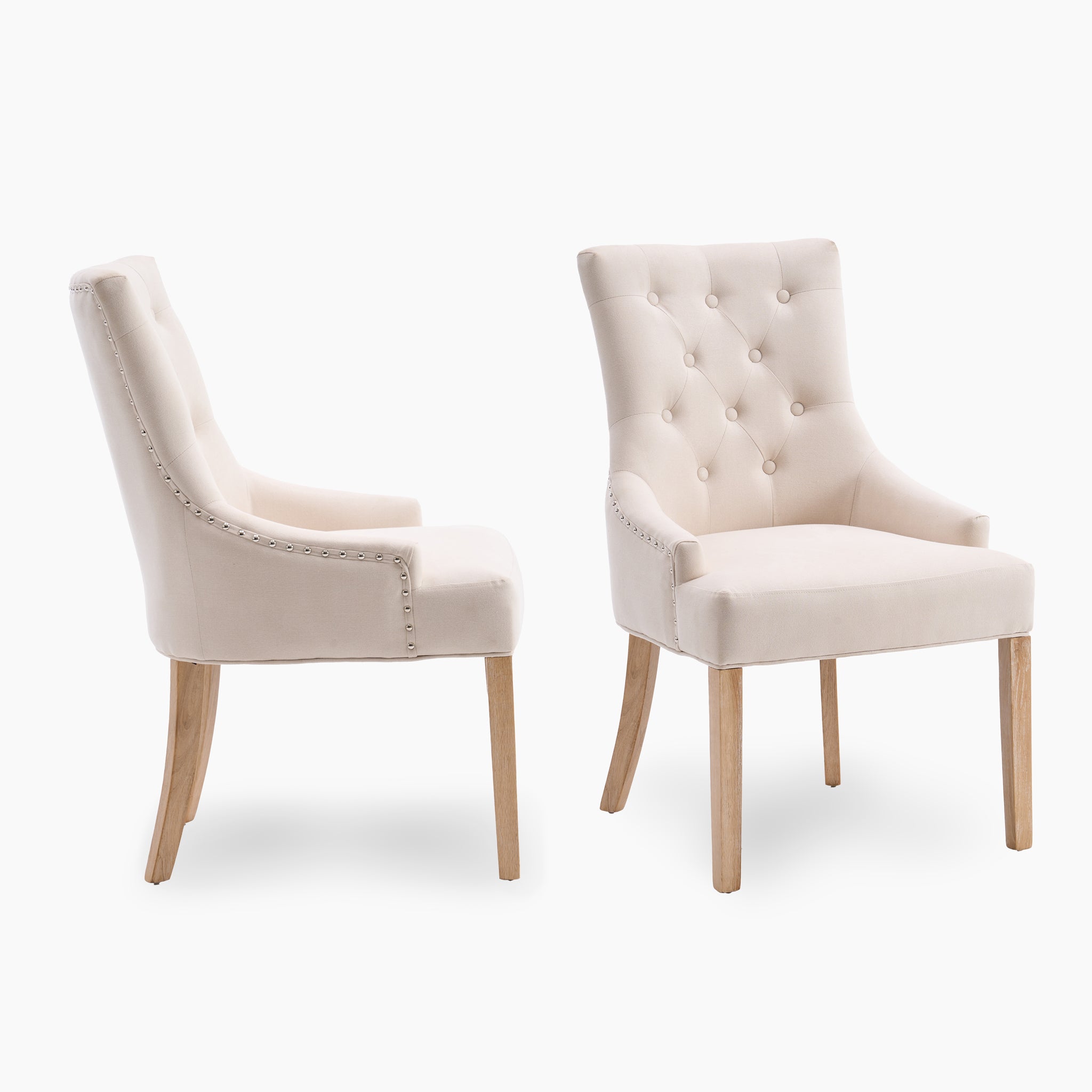 The Regent Chair Set of 2 in Ivory features elegant, ivory upholstered chairs with wooden legs and tufted backs, resting gracefully against a white background.