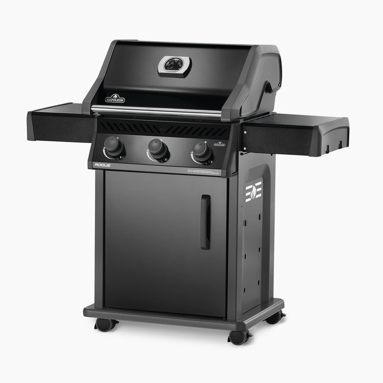 The Napoleon Rogue 425 Gas Barbecue, a black freestanding propane grill, offers precise temperature control with its integrated lid thermometer, intuitive control knobs, and handy side shelves.