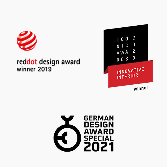 Three design awards: 2019 Red Dot, 2020 Iconic Innovative Interior, and 2021 German Design Award Special Mention for the Höfats SPIN 1200 Tabletop Fireplace Gold, featuring a decorative glass cylinder and bioethanol flame.