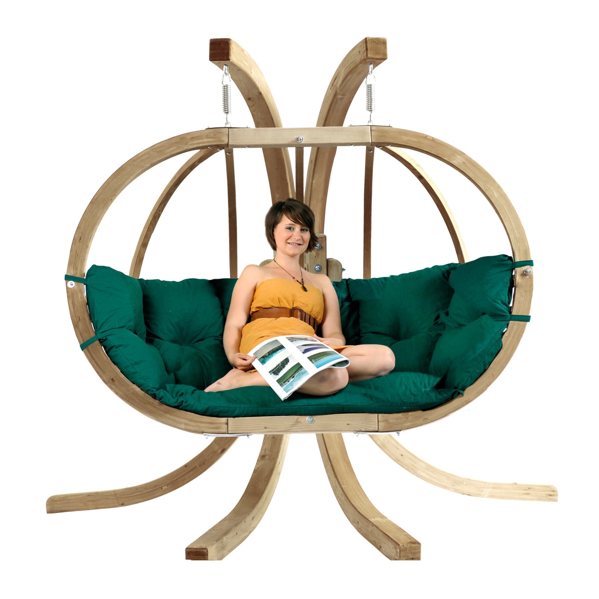 A woman in an orange dress relaxes and reads on a Globo Royal Double Seater Hanging Chair Set, featuring weatherproof spruce wood frame and green cushions in Verde Green.