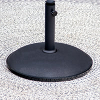 Close-up of a 15kg Concrete Parasol Base, featuring its sleek black metal stand on a light-colored textured surface.