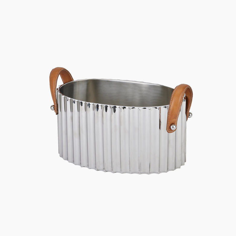 The Large Silver Fluted Leather Handled Champagne Cooler from Hill Interiors features an elegant oval ribbed metal design with brown leather handles on both sides, making it perfect for stylishly chilling champagne.