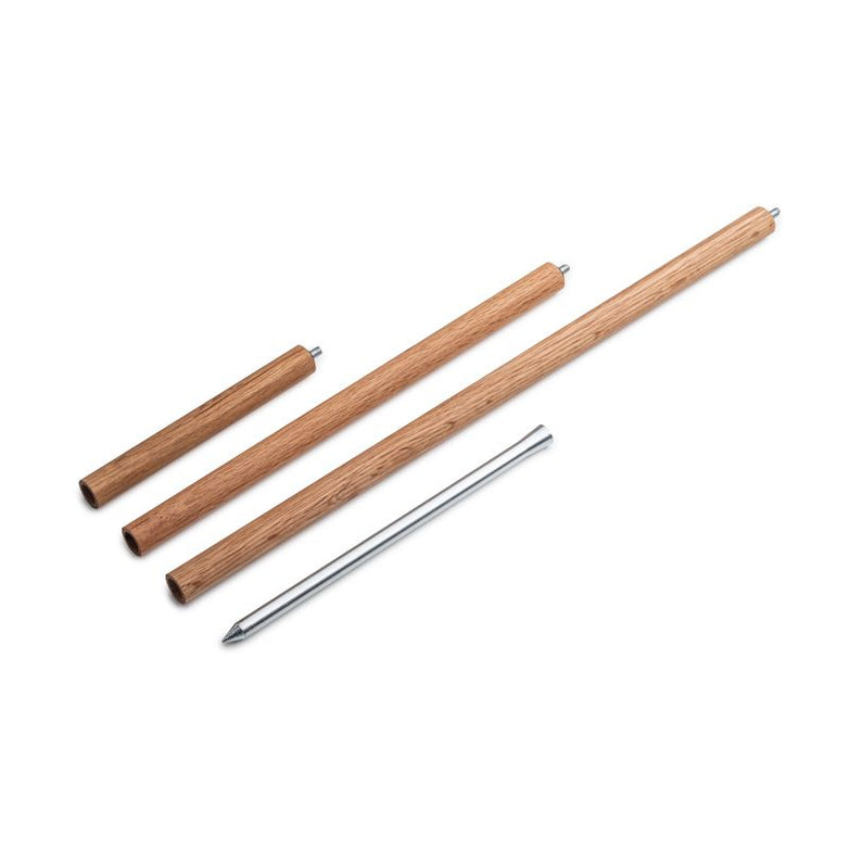 Four wooden dowels of varying lengths and a metal rod, part of the Höfats SPIN Ground Spike Oak 3-part set, are laid out on a white background.