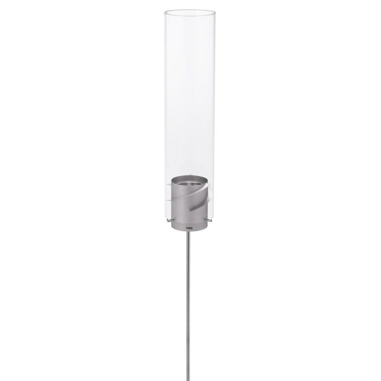 Höfats SPIN Ground Spike grey lamp features a tall, cylindrical glass hurricane lampshade with a metal base and a slender, vertical rod stand—an eye-catching addition for any garden party.