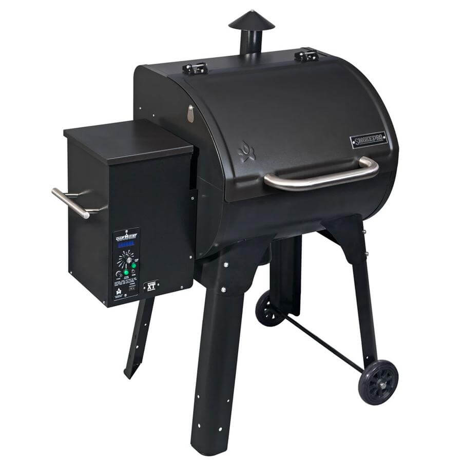 The Camp Chef XT 24 Pellet Grill in black features a side hopper, control panel, and chimney on four sturdy legs, two of which have wheels. Its Simple Ash-Cleanout System ensures quick cleanup while the Smart Smoke Technology guarantees perfect grilling control.