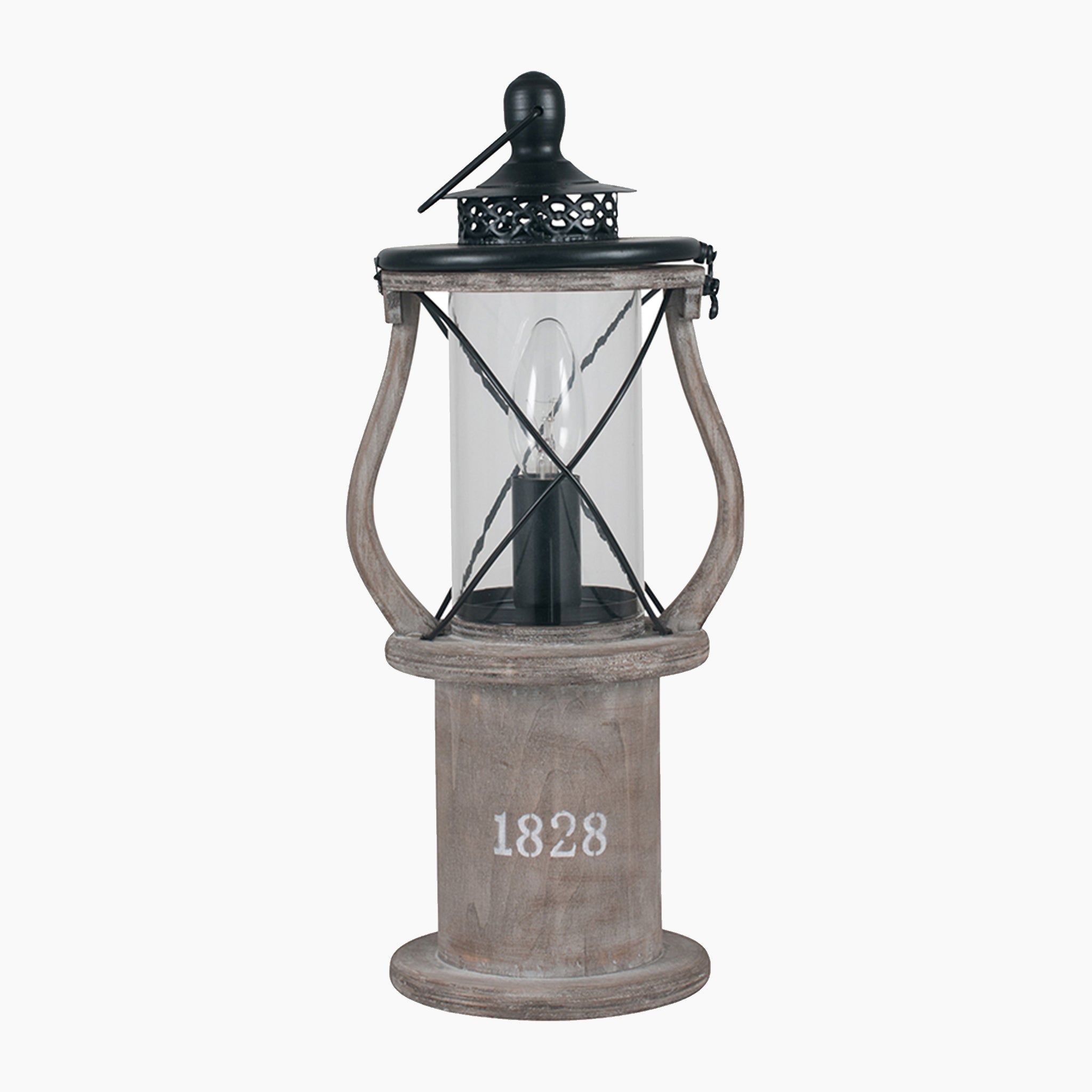 The Gibson Wood Lantern Table Lamp in Antique Wood features a transparent casing, a black top, and "1828" printed on a wooden base, capturing the essence of Victorian lantern styling.