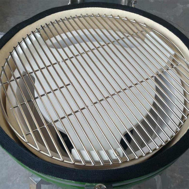 A top-down view of an empty 22" Kamado ceramic grill featuring the Kamado Heat Deflector and a metal grate inside.