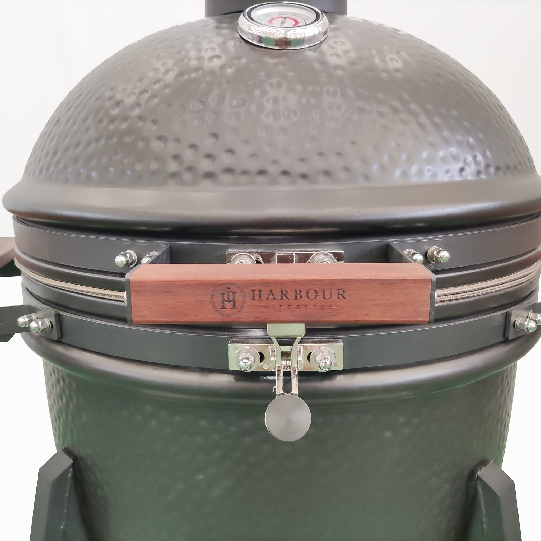 Close-up of a Kamado BBQ 22" Ceramic Grill in Black with a thermometer on the lid and a wooden handle. The brand "Harbour" is visible. Perfect for use as a charcoal smoker, this black grill promises precision and style in one elegant package.