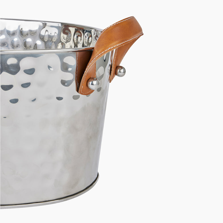 The Silver Large Leather Handled Champagne Cooler, featuring high-quality leather handles and a hammered metal design, stands chic against a white background.